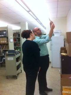 Two Eaton archivists studying a Klein shipment.