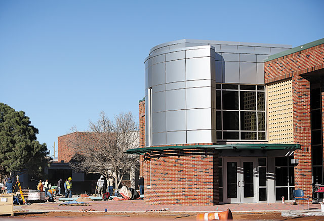 The exterior of the Jack Williamson Liberal Arts building seen as workers pour concrete and lay bricks outside the facility’s west entrance.