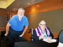 Mike Glyer watches Ray Bradbury autograph, on Opening Day of Monrovia Public Library