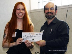 Jean-Louis Trudel of SF Canada hands Ariane Gélinas, the winner of the Aurora-Boréal Award for best novel, a presentation cheque for $500. Photo (c) 2013 by Charles Mohapel.