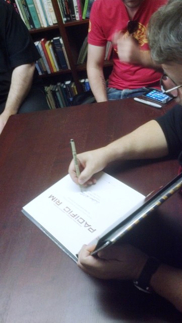 Signing Jim's copy of Pacific Rim. Photo by John King Tarpinian.