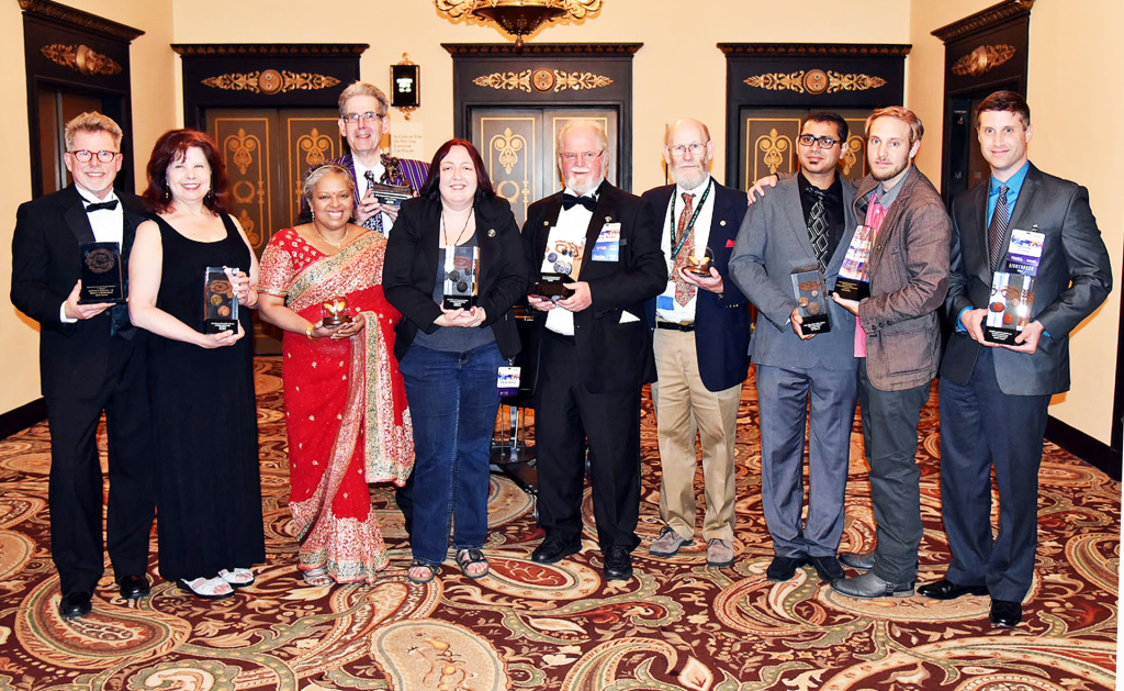 Winners and accepters at Nebula Awards ceremony: (L to R) Steven Gould, Nancy Kress, (?), (?), Ursula Vernon, Larry Niven, Stanley Schmidt, (?), (?), (?)