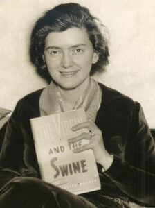 black and white photo of Evangeline Walton from 1936 holding hardcover of Virgin and the Swine