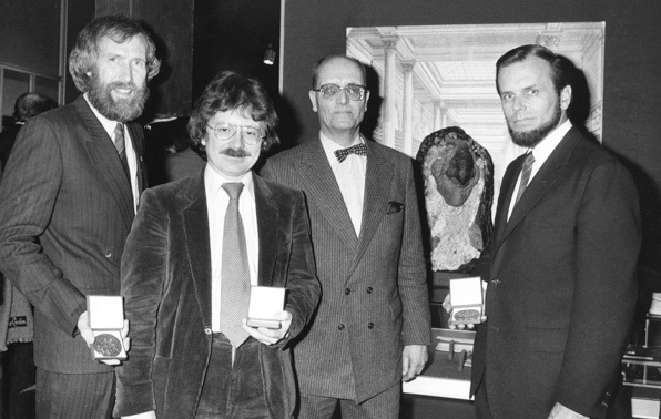 Jim Henson, Brian Froud, a French official, and Gary Kurtz at the “Exposition de Cristaux Geants” in Paris, 1983. Between the official and Kurtz is a Skeksis, a creature from The Dark Crystal.