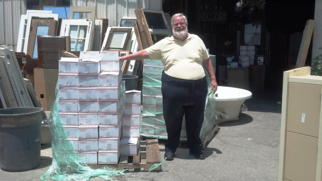 Mike Glyer with Bradbury bookends ready for shipping at ReUse People.