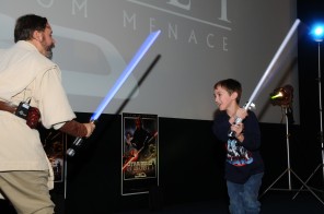 Shawn Crosby shown teaching a kid how to wield the light saber. From an article in The Washington Post.