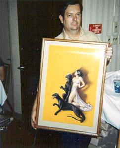 Richard Clear shows off an original Brundage Weird Tales cover painting at PULPcon (year unknown). Photo by Robert Weinberg.